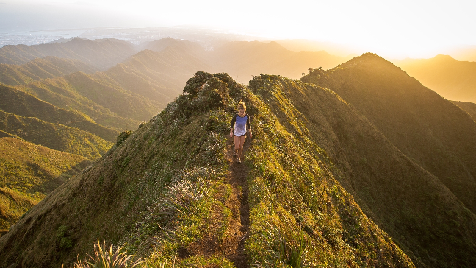 A woman on a hilltop trail.
